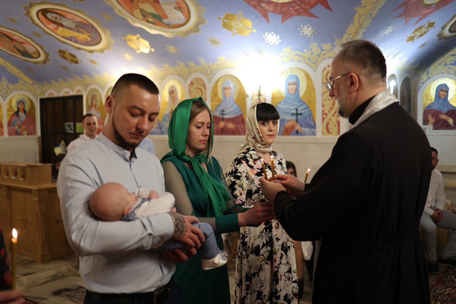 Priest performing the infant baptism rite