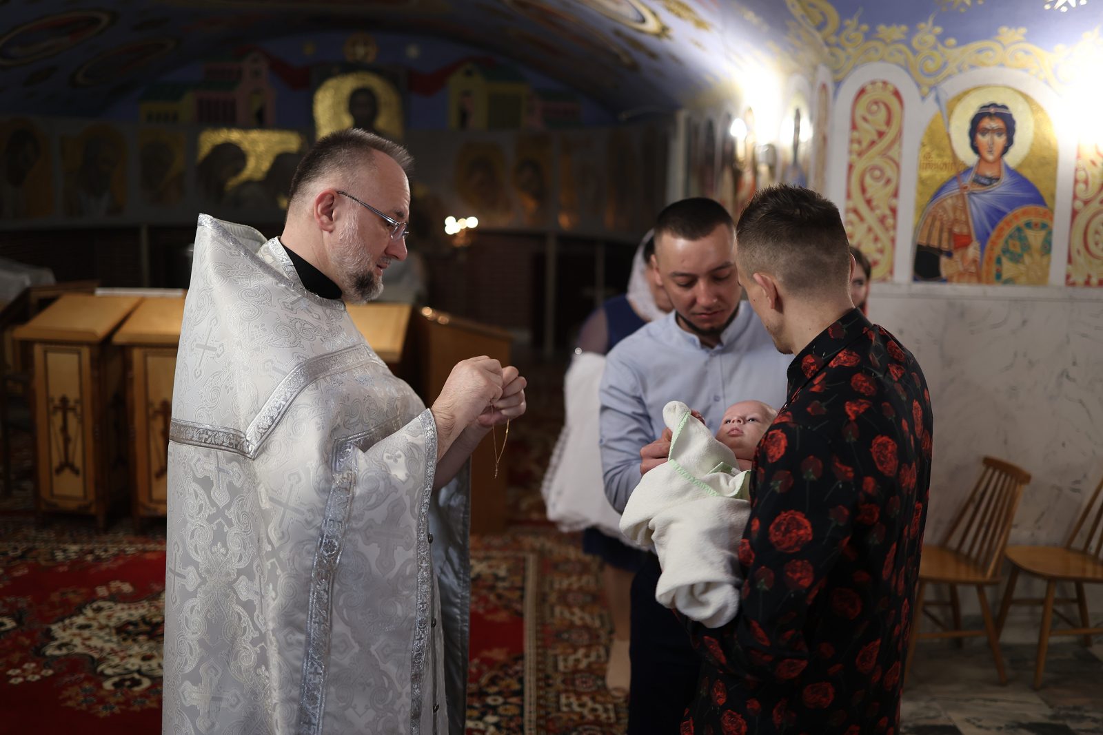Priest reading a prayer by the altar