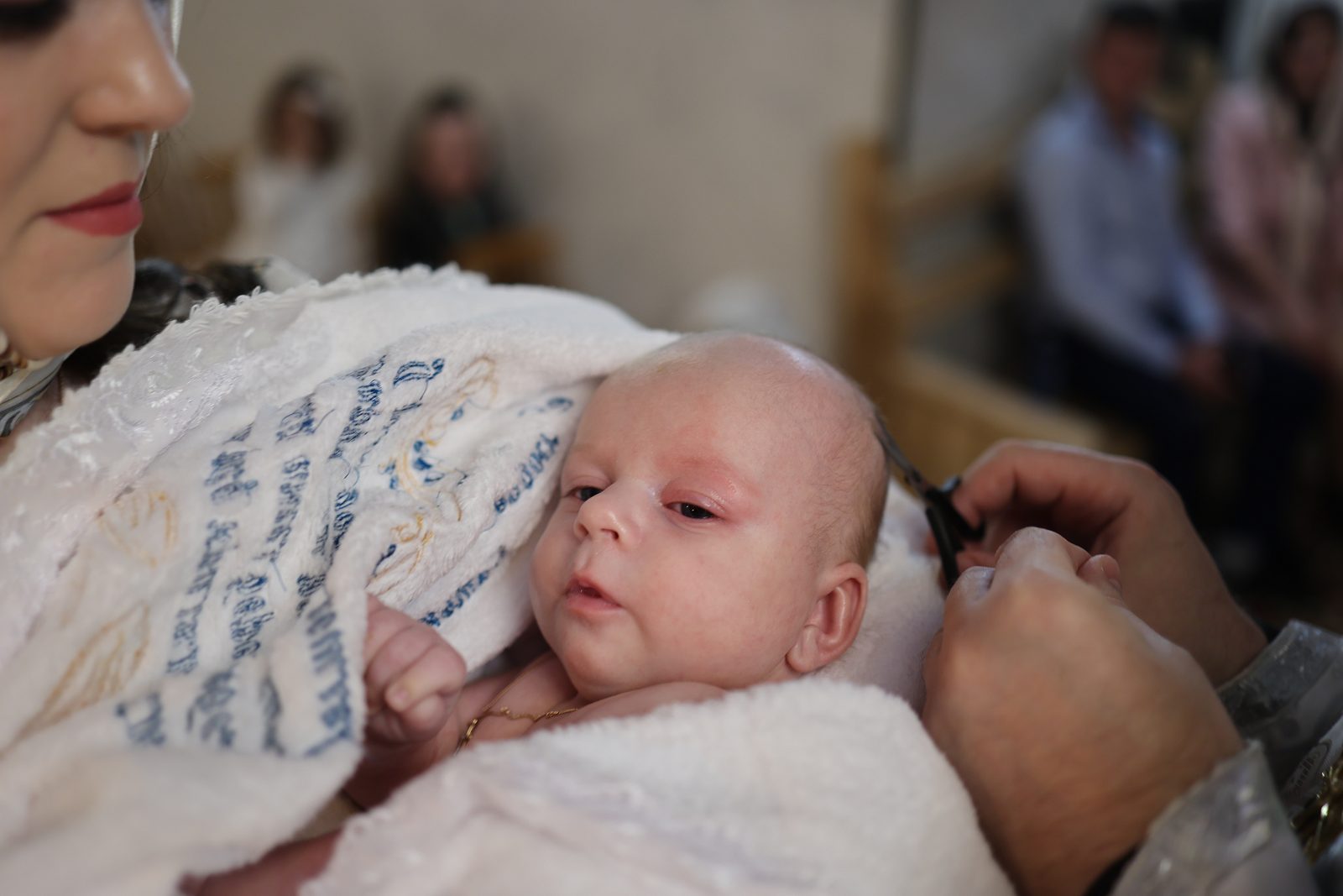 Portrait of an infant in white baptism clothing