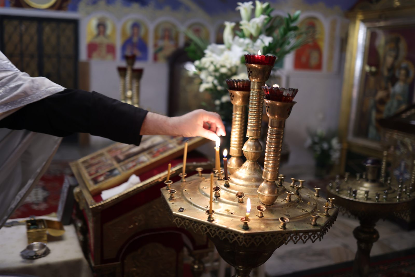 Lit candles on a stand in an Orthodox church