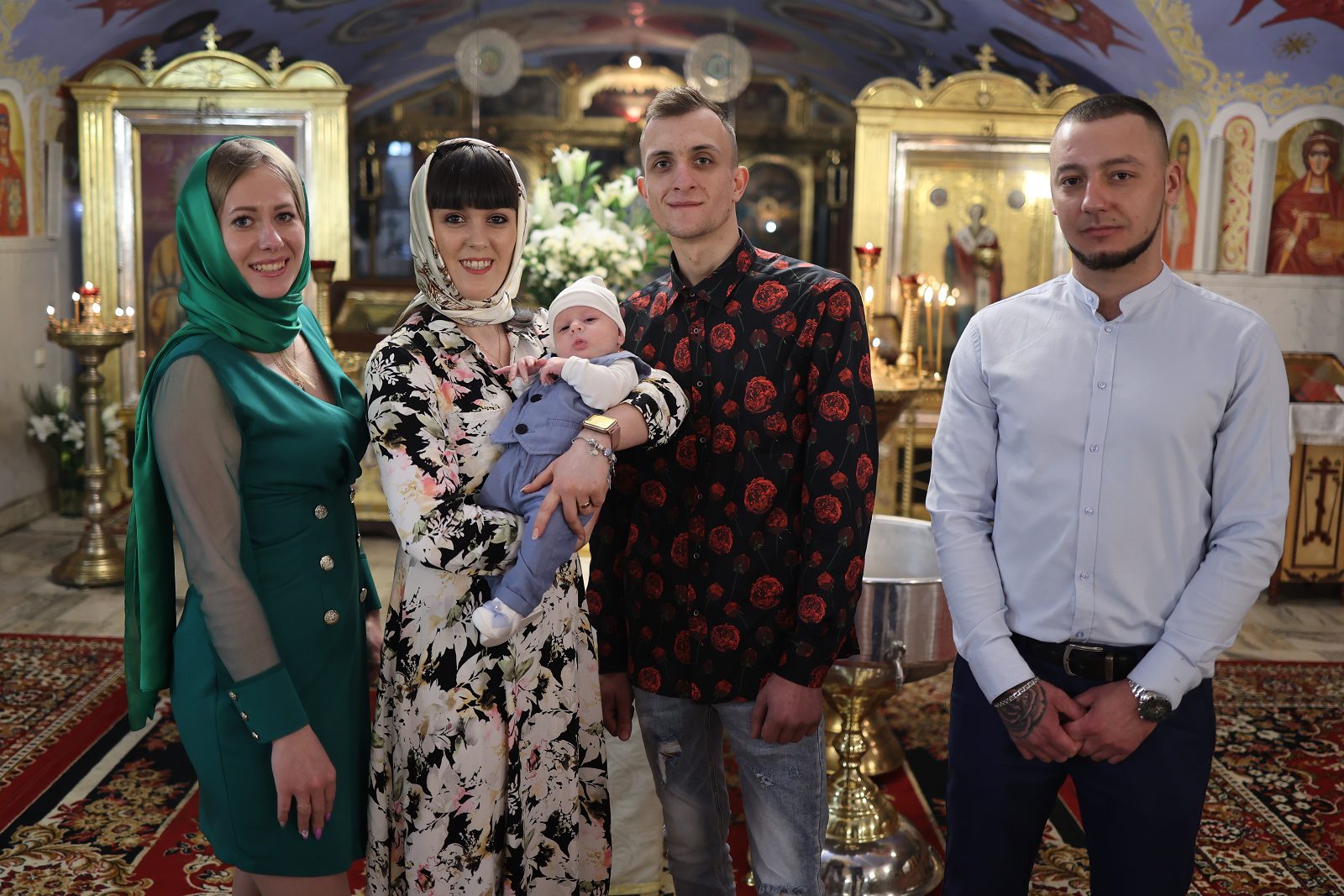 Family with an infant posing in church