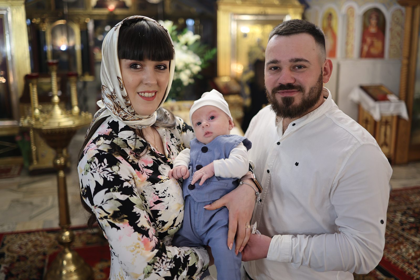 Couple posing with an infant in church