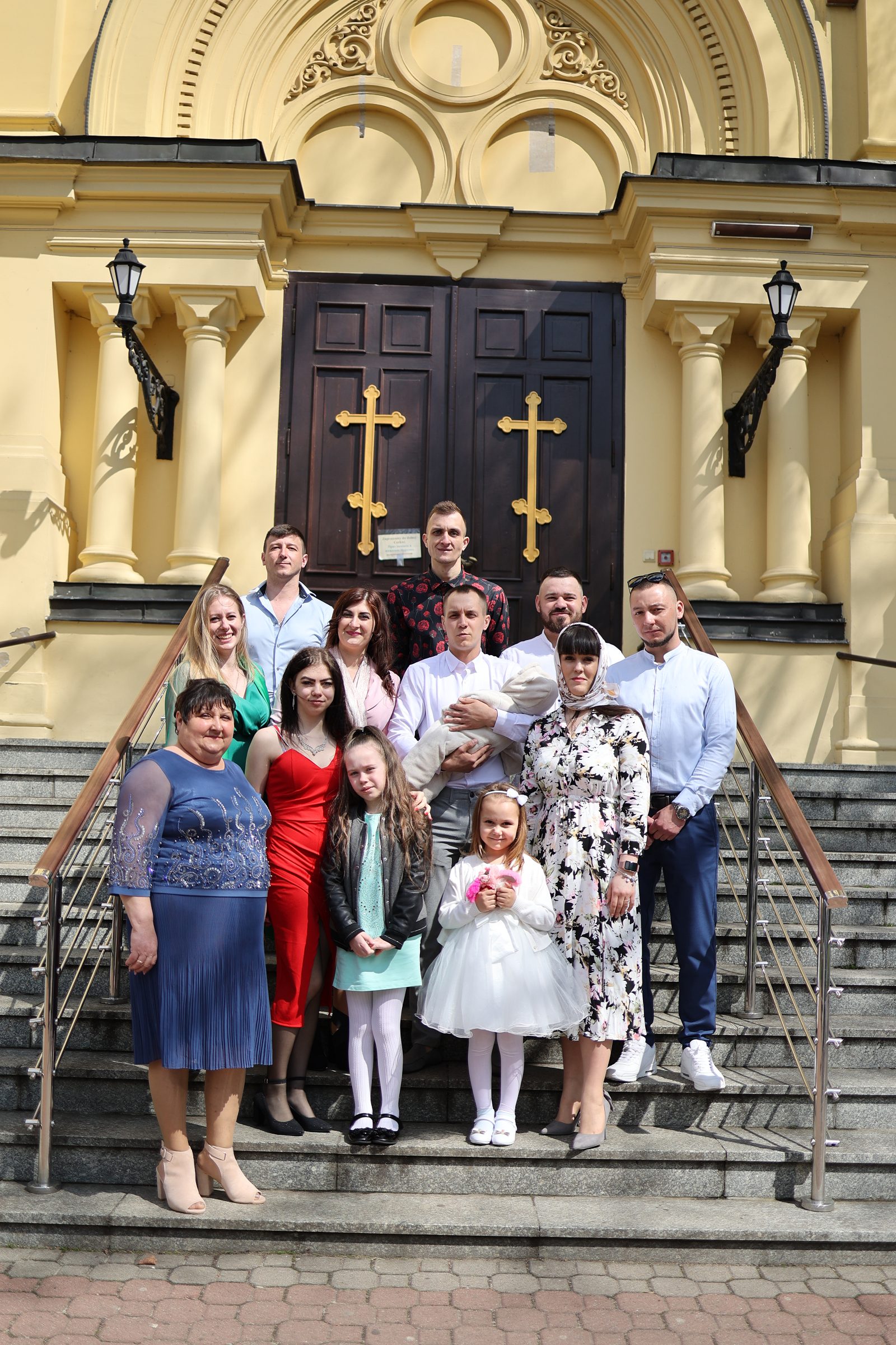 Family posing on steps before the church entrance