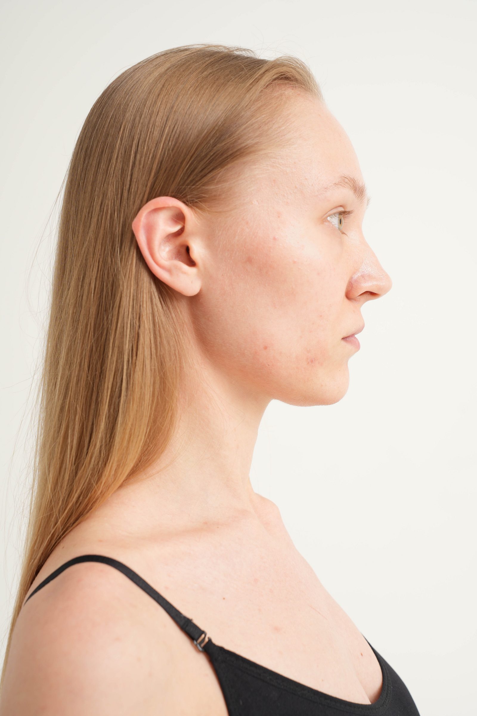 Right-profile portrait of a woman against a white background