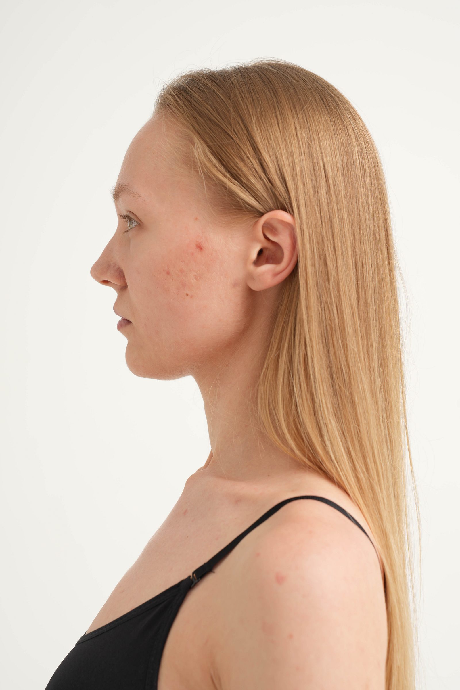 Left-profile portrait of a woman against a white background