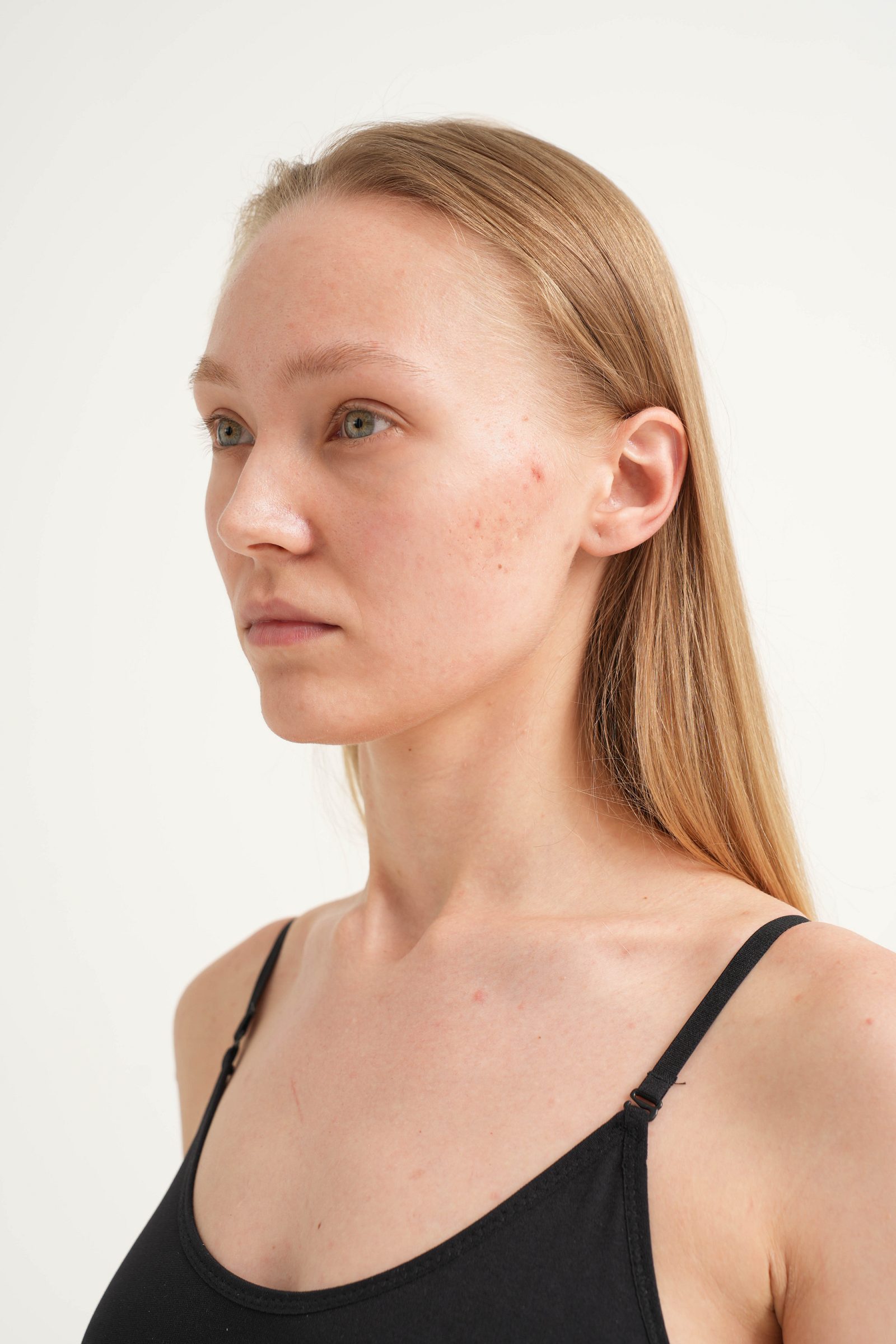 Left three-quarter portrait of a woman against a white background